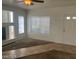 Open-concept living room with a fireplace, large windows, and tile and carpet flooring at 8829 Cornwall Glen Ave, Las Vegas, NV 89129