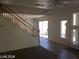 Bright living space with staircase, leading to backyard through sliding glass door at 8829 Cornwall Glen Ave, Las Vegas, NV 89129
