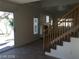 Spacious living room featuring tile floors, stairs, and access to an outdoor patio at 8829 Cornwall Glen Ave, Las Vegas, NV 89129