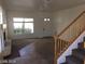 Inviting living room featuring a fireplace, staircase, large windows, and a welcoming layout at 8829 Cornwall Glen Ave, Las Vegas, NV 89129