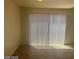Backyard access through a sliding glass door and vertical blinds at 8829 Cornwall Glen Ave, Las Vegas, NV 89129