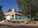 Community pool area with a fence, lush landscaping, and a 'Speed Limit 15 MPH' sign at 8829 Cornwall Glen Ave, Las Vegas, NV 89129