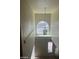 A staircase with large windows allowing natural light to fill the area at 8829 Cornwall Glen Ave, Las Vegas, NV 89129