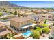 Expansive backyard featuring a refreshing pool, covered patio, manicured lawn and playground equipment at 885 Violet Hill St, Las Vegas, NV 89110