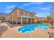 Back of house featuring a pool, spa, and covered patio perfect for relaxing and entertaining at 885 Violet Hill St, Las Vegas, NV 89110