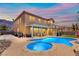 Gorgeous backyard featuring a large pool, jacuzzi, and covered patio, perfect for entertaining at 885 Violet Hill St, Las Vegas, NV 89110