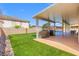 Relaxing backyard area with covered patio, artificial grass and shade, perfect for outdoor living at 885 Violet Hill St, Las Vegas, NV 89110