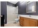 Standard bathroom includes a shower, toilet, vanity with sink, and large framed mirror at 885 Violet Hill St, Las Vegas, NV 89110