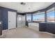 A primary bathroom with a soaking tub with a view, a stand-up shower, and neutral tile floors at 885 Violet Hill St, Las Vegas, NV 89110