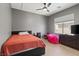 A cozy bedroom with a ceiling fan, a window, and a queen bed at 885 Violet Hill St, Las Vegas, NV 89110