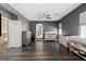 Spacious bedroom with dark floors, ceiling fan, walk-in closet and two storage dressers at 885 Violet Hill St, Las Vegas, NV 89110