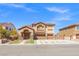 Charming two-story house with a three-car garage, manicured lawn, and inviting entryway at 885 Violet Hill St, Las Vegas, NV 89110