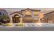 Inviting two-story home featuring a three-car garage and elegant architectural details at 885 Violet Hill St, Las Vegas, NV 89110