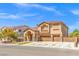 Charming two-story house with a three-car garage, manicured lawn, and inviting entryway at 885 Violet Hill St, Las Vegas, NV 89110