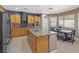 Spacious kitchen features an island with stainless steel sink, plenty of cabinetry, and an eat-in breakfast nook at 885 Violet Hill St, Las Vegas, NV 89110