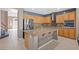 Spacious kitchen features stainless appliances, an island with stainless steel sink, and plenty of cabinetry at 885 Violet Hill St, Las Vegas, NV 89110