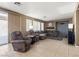 Spacious living room has neutral paint, an ornate fireplace and sliding glass doors to the backyard at 885 Violet Hill St, Las Vegas, NV 89110