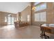 Bright living room featuring high ceilings, natural light, and elegant tile flooring at 885 Violet Hill St, Las Vegas, NV 89110