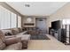 Spacious living room has neutral paint, an ornate fireplace and sliding glass doors to the backyard at 885 Violet Hill St, Las Vegas, NV 89110