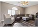 Inviting living room features a ceiling fan and generous natural light from a large arched window at 885 Violet Hill St, Las Vegas, NV 89110