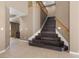 Elegant staircase with dark wood steps and light wood railings, creating a warm ambiance at 885 Violet Hill St, Las Vegas, NV 89110