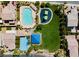 Aerial view of community amenities including a swimming pool, playground, covered picnic area, and basketball court for residents at 8929 Sleepy Panda Ave, Las Vegas, NV 89148