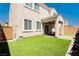 Private backyard with artificial turf, covered patio, and potential for landscaping, creating a perfect outdoor living space at 8929 Sleepy Panda Ave, Las Vegas, NV 89148