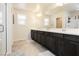 Bright bathroom with double sink vanity, large mirror and tiled floor at 8929 Sleepy Panda Ave, Las Vegas, NV 89148