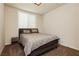 Neutral bedroom featuring a queen bed with striped duvet and carpeted flooring at 8929 Sleepy Panda Ave, Las Vegas, NV 89148