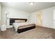 Spacious bedroom featuring a bed with black headboard and carpeted floors at 8929 Sleepy Panda Ave, Las Vegas, NV 89148