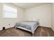 Cozy bedroom featuring a twin bed with gray duvet, and a large window for natural light at 8929 Sleepy Panda Ave, Las Vegas, NV 89148