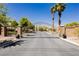 Gated community entrance with wrought iron gate and brick pillars, providing security and enhancing curb appeal at 8929 Sleepy Panda Ave, Las Vegas, NV 89148