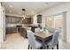 Bright kitchen with stainless steel appliances, tile backsplash, and adjacent dining area with backyard access at 8929 Sleepy Panda Ave, Las Vegas, NV 89148