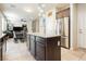 Open concept kitchen with granite island, stainless appliances, and tile floors at 8929 Sleepy Panda Ave, Las Vegas, NV 89148