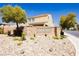 Inviting community entrance with stone signage, mature trees, and well-maintained landscaping, conveying a welcoming atmosphere at 8929 Sleepy Panda Ave, Las Vegas, NV 89148