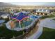 Aerial view showcases a playground, pool, and other community amenities at 8968 Skye Treeline St, Las Vegas, NV 89166