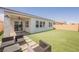 Backyard featuring artificial grass and comfortable seating at 8968 Skye Treeline St, Las Vegas, NV 89166
