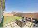 Backyard featuring artificial grass and comfortable seating at 8968 Skye Treeline St, Las Vegas, NV 89166
