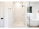 Bright bathroom features glass enclosed shower with a seat and soaking tub at 8968 Skye Treeline St, Las Vegas, NV 89166