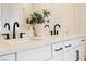Bathroom featuring dual vanities, marble countertops, and black modern hardware at 8968 Skye Treeline St, Las Vegas, NV 89166