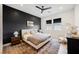Modern bedroom features a bold accent wall, neutral furniture and wood-look floors at 8968 Skye Treeline St, Las Vegas, NV 89166