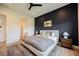 Nicely styled bedroom with dark blue accent wall and wood-look floors at 8968 Skye Treeline St, Las Vegas, NV 89166