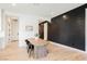 Bright dining room features light wood floors, designer accent wall, and a modern farmhouse dining table at 8968 Skye Treeline St, Las Vegas, NV 89166