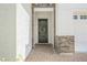 Close up of the front door with lovely brick accents and desert landscaping at 8968 Skye Treeline St, Las Vegas, NV 89166