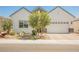 Charming home with a two-car garage, desert landscaping, and attractive architectural details at 8968 Skye Treeline St, Las Vegas, NV 89166