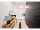 Inviting hallway with a stylish wooden console table and decorative mirror at 8968 Skye Treeline St, Las Vegas, NV 89166