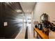 Long hallway features wood-like floors, a plank accent wall, and decorative console table at 8968 Skye Treeline St, Las Vegas, NV 89166