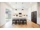 Bright kitchen features white cabinetry, stainless appliances, and large island with seating and stylish pendant lighting at 8968 Skye Treeline St, Las Vegas, NV 89166