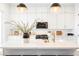 Bright kitchen features white cabinetry, stainless appliances, and large island with seating and pendant lighting at 8968 Skye Treeline St, Las Vegas, NV 89166