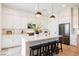 Modern kitchen featuring a center island with bar seating, stainless appliances, and stylish pendant lighting at 8968 Skye Treeline St, Las Vegas, NV 89166